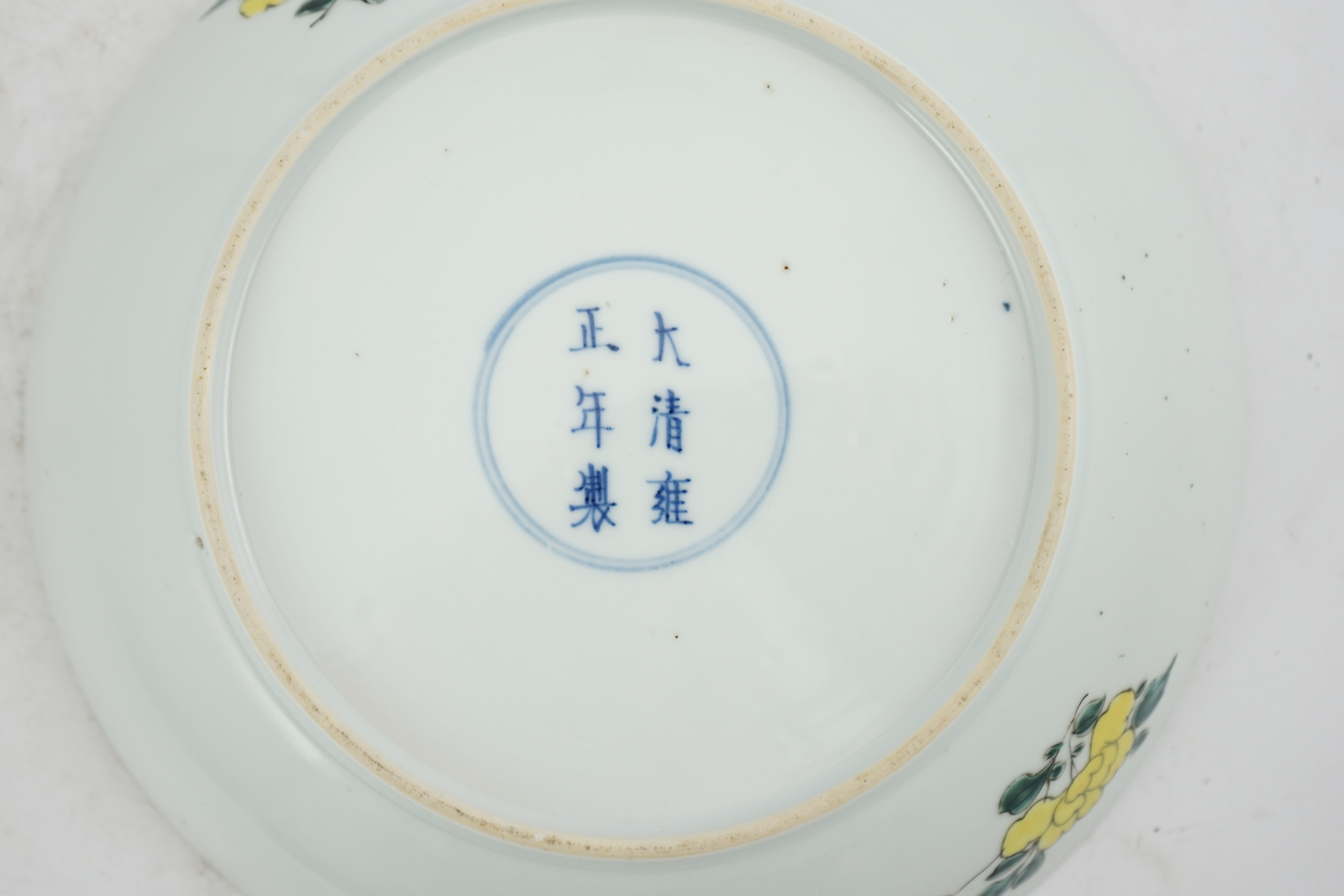 A Chinese famille rose ‘peony and prunus’ saucer dish, Yongzheng mark and period (1723-35)